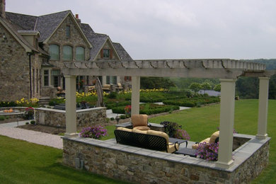 Patio - large traditional backyard concrete paver patio idea in Baltimore with a pergola
