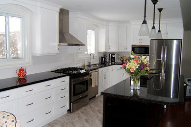 Elegant eat-in kitchen photo in Toronto with shaker cabinets, white cabinets and granite countertops