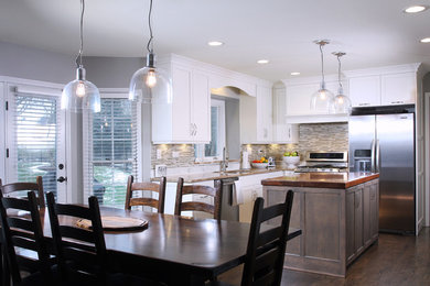 Mid-sized trendy l-shaped dark wood floor and brown floor eat-in kitchen photo in Chicago with an undermount sink, shaker cabinets, white cabinets, granite countertops, beige backsplash, matchstick tile backsplash, stainless steel appliances and an island