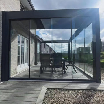 Louvered Motorized Pergola With Sliding Glass Door