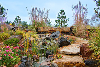 Inspiration for a mid-sized traditional partial sun backyard stone landscaping in Denver with a fire pit for spring.