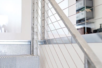 Inspiration for a small modern metal straight metal railing staircase remodel in Chicago with metal risers