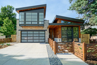 Photo of a contemporary two-storey brown house exterior in Albuquerque with mixed siding and a shed roof.