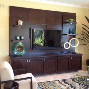This is an example of a small open plan home cinema in Los Angeles with yellow walls and a built-in media unit.