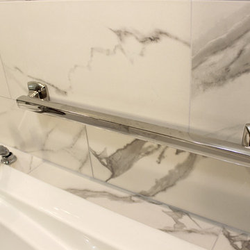 White and Gray MasterBath with Marble Look and Herringbone Tiled Shower