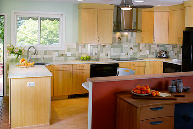 Inspiration for a mid-sized contemporary l-shaped linoleum floor eat-in kitchen remodel in Philadelphia with an undermount sink, flat-panel cabinets, light wood cabinets, recycled glass countertops, black appliances, green backsplash, glass tile backsplash and a peninsula