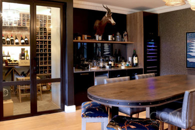 Home bar photo in Other with an undermount sink, black cabinets, quartz countertops, mirror backsplash and gray countertops