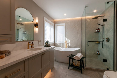 Inspiration for a mid-sized transitional master multicolored tile and porcelain tile porcelain tile, multicolored floor and double-sink bathroom remodel in Toronto with recessed-panel cabinets, gray cabinets, a two-piece toilet, beige walls, an undermount sink, quartz countertops, a hinged shower door, white countertops and a built-in vanity