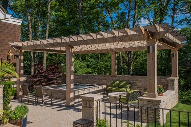 Inspiration for a large backyard concrete paver patio remodel in Other with a fire pit and a pergola