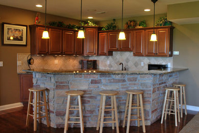 Inspiration for a transitional dark wood floor home bar remodel in Chicago with recessed-panel cabinets, medium tone wood cabinets, granite countertops and beige backsplash