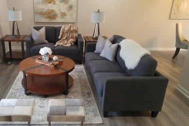 Inspiration for a mid-sized contemporary open concept laminate floor and multicolored floor living room remodel in Other with beige walls