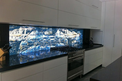 Modern kitchen in Sydney with glass sheet splashback.