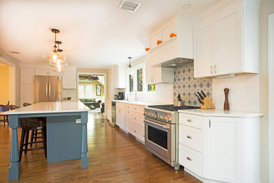 Example of a large trendy l-shaped medium tone wood floor and brown floor eat-in kitchen design in Boston with a single-bowl sink, recessed-panel cabinets, white cabinets, quartzite countertops, white backsplash, ceramic backsplash, stainless steel appliances, an island and white countertops