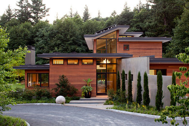 Inspiration for a large contemporary three-storey brown exterior in Portland with wood siding and a flat roof.