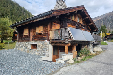 Inspiration pour une façade de maison marron chalet en bois de taille moyenne et à trois étages et plus avec un toit à deux pans.