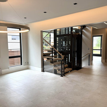 Project #136 | Modern Floating Staircase Encircling Glass Elevator