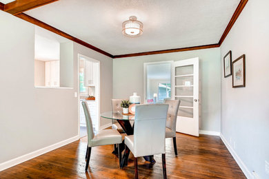 Inspiration for a mid-sized transitional medium tone wood floor and brown floor great room remodel in Minneapolis with gray walls and no fireplace