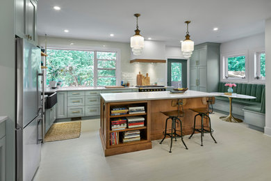 Eat-in kitchen - mid-sized traditional l-shaped ceramic tile and beige floor eat-in kitchen idea in Edmonton with a farmhouse sink, shaker cabinets, gray cabinets, quartz countertops, white backsplash, ceramic backsplash, stainless steel appliances, an island and white countertops