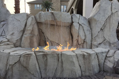 Large trendy backyard stone patio fountain photo in Indianapolis with no cover