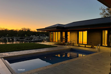 Pool - mid-sized 1950s concrete paver natural pool idea in Chicago
