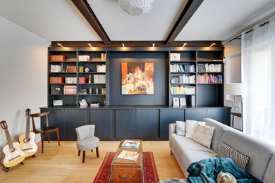 Idées déco pour une salle de séjour ouverte avec une bibliothèque ou un coin lecture, un mur noir, parquet clair, poutres apparentes et éclairage.