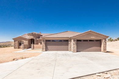 Mid-sized transitional brown one-story stucco exterior home photo in Phoenix with a hip roof