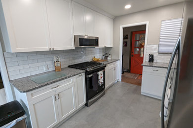 Example of a mid-sized trendy galley eat-in kitchen design in Oklahoma City with shaker cabinets, white cabinets and granite countertops