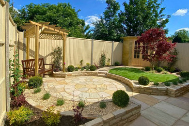 Inspiration for a small world-inspired back formal partial sun pergola for summer in Other with natural stone paving and a wood fence.