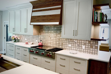 Eat-in kitchen - huge transitional l-shaped medium tone wood floor and brown floor eat-in kitchen idea in Chicago with an undermount sink, flat-panel cabinets, white cabinets, quartzite countertops, beige backsplash, glass tile backsplash, stainless steel appliances, an island and white countertops