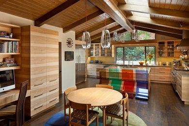 Mid-sized midcentury l-shaped eat-in kitchen in Los Angeles with flat-panel cabinets, light wood cabinets, yellow splashback, stainless steel appliances, an undermount sink, solid surface benchtops, matchstick tile splashback, dark hardwood floors and with island.