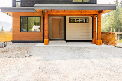 Example of a huge trendy multicolored two-story mixed siding house exterior design in Other