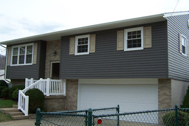Example of a mid-sized gray two-story mixed siding exterior home design in Other