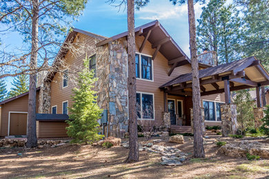 Large rustic brown two-story exterior home idea with a shingle roof