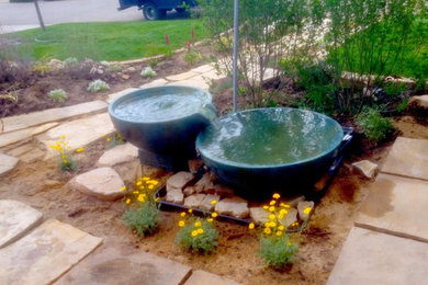 This is an example of a small farmhouse full sun front yard brick landscaping in Denver for spring.