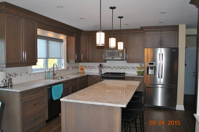 Eat-in kitchen - transitional eat-in kitchen idea in Toronto with an undermount sink, shaker cabinets, medium tone wood cabinets, quartz countertops, stainless steel appliances and an island