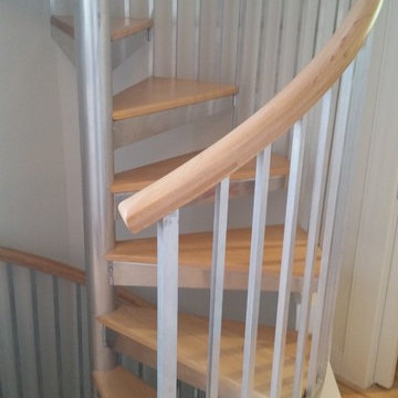 Spiral stairs with wood maple treads and handrail.