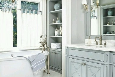 Inspiration for a large contemporary master marble floor and white floor freestanding bathtub remodel in Phoenix with furniture-like cabinets, gray cabinets, gray walls, an undermount sink, marble countertops and white countertops