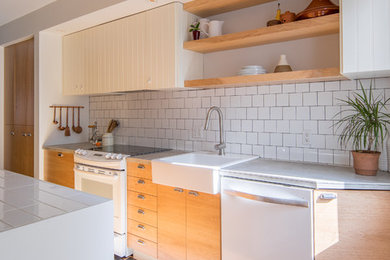 Inspiration for a mid-sized contemporary galley ceramic tile and gray floor eat-in kitchen remodel in Montreal with a single-bowl sink, flat-panel cabinets, medium tone wood cabinets, tile countertops, white backsplash, ceramic backsplash, white appliances and an island