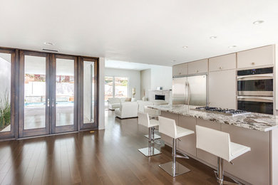 Example of a minimalist eat-in kitchen design in Albuquerque with granite countertops and stainless steel appliances