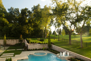 Mid-sized minimalist backyard custom-shaped hot tub photo in Other