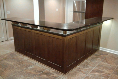 Example of a transitional u-shaped eat-in kitchen design in Chicago with an undermount sink, shaker cabinets, dark wood cabinets, granite countertops and stainless steel appliances