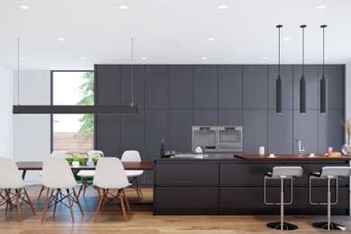 Example of a huge minimalist single-wall eat-in kitchen design in Toronto with flat-panel cabinets, gray cabinets and an island