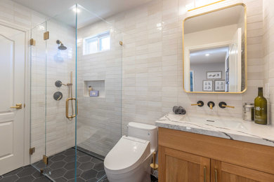 Inspiration for a transitional beige tile and subway tile gray floor and single-sink corner shower remodel in San Francisco with shaker cabinets, medium tone wood cabinets, an undermount sink, a hinged shower door, white countertops and a niche