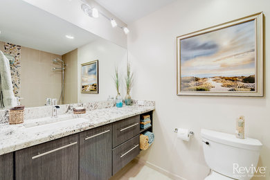 Bathroom - mid-sized traditional master bathroom idea in Chicago with flat-panel cabinets, medium tone wood cabinets, a two-piece toilet, beige walls, a drop-in sink and marble countertops