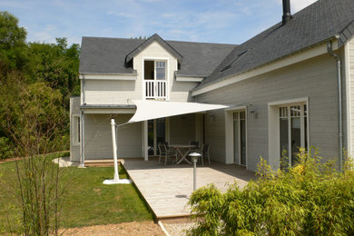 This is an example of a beach style home design in Le Havre.