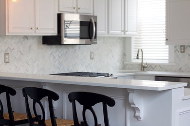 Mid-sized transitional u-shaped dark wood floor and brown floor open concept kitchen photo in New York with an undermount sink, raised-panel cabinets, white cabinets, quartzite countertops, white backsplash, marble backsplash, stainless steel appliances and an island