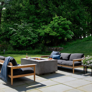 Bluestone Patio with Fire Pit and Teak Sofas Facing Garden