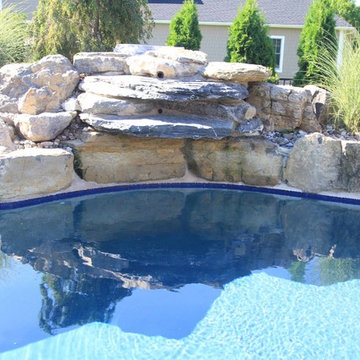 Custom Freeform style salt water in ground pool with Pool House and Raised Spa