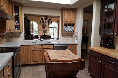 Mid-sized traditional l-shaped separate kitchen in Phoenix with an undermount sink, recessed-panel cabinets, light wood cabinets, granite benchtops, beige splashback, ceramic splashback, stainless steel appliances, with island and white benchtop.