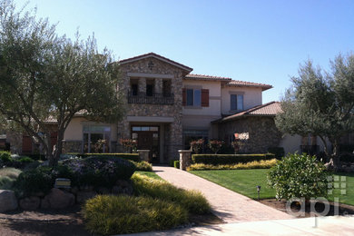 This is an example of a mid-sized mediterranean two-storey stucco beige exterior in Sacramento.
